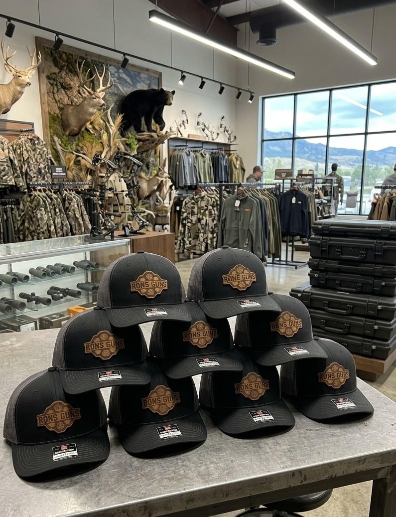 Group of eight Ron’s Guns custom-logo hats — bulk-order design mockup